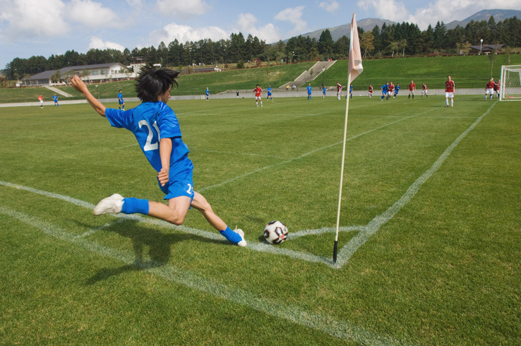 Youth Soccer Player Taking a Corner Kick